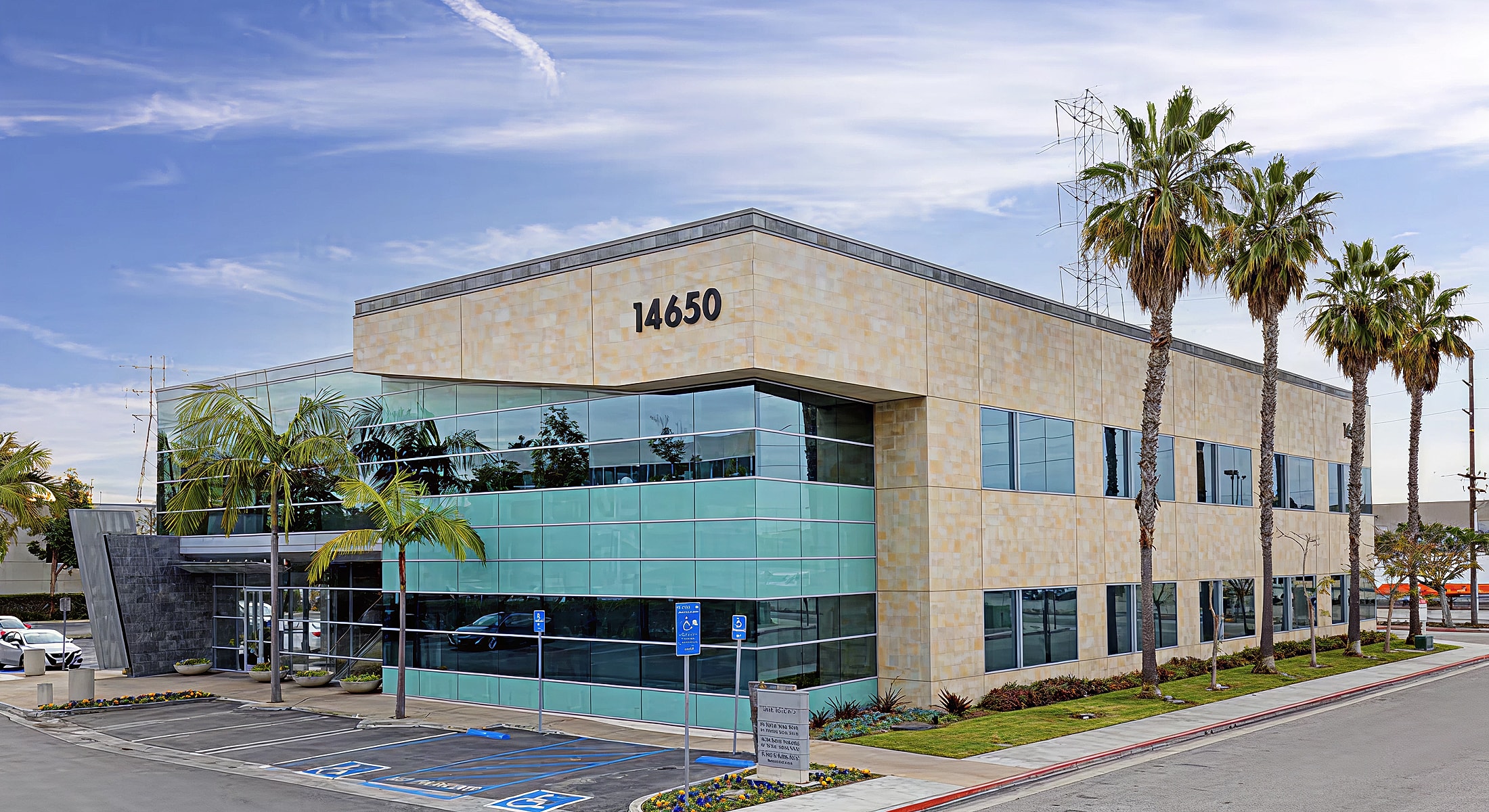 Modern commercial building with palm trees.