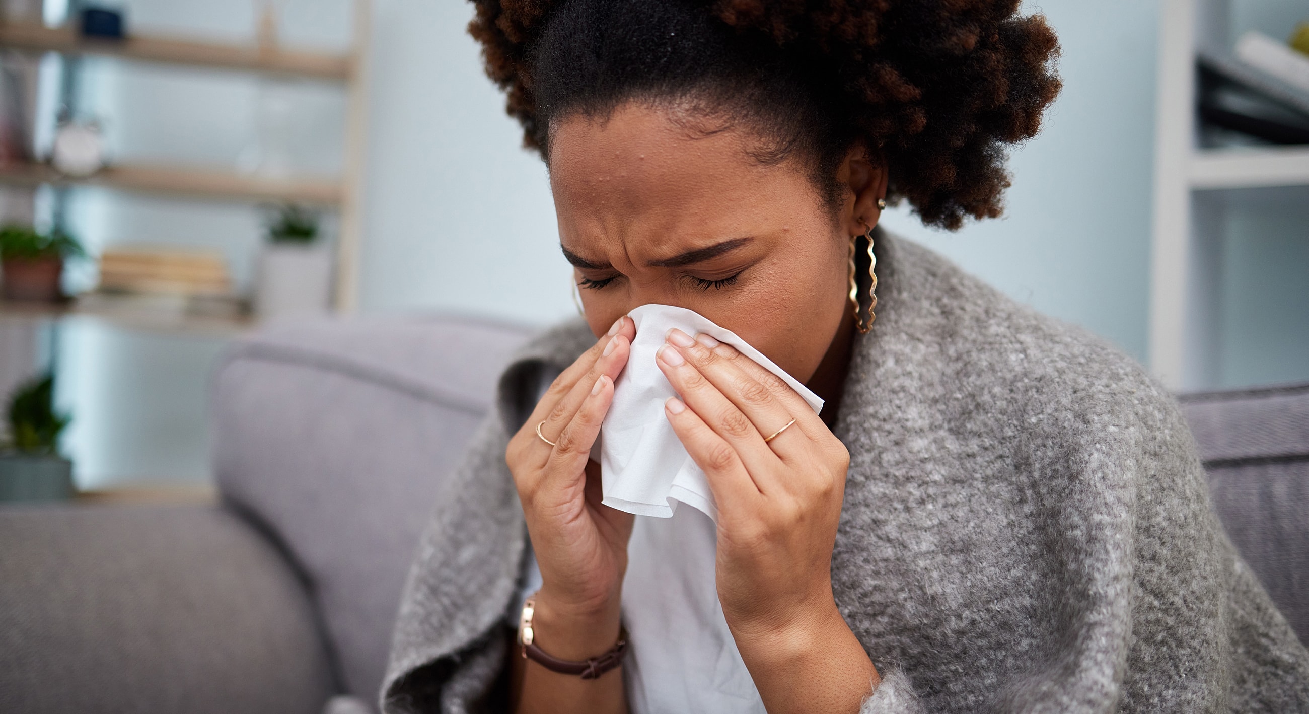 Woman with a tissue showing signs of distress.