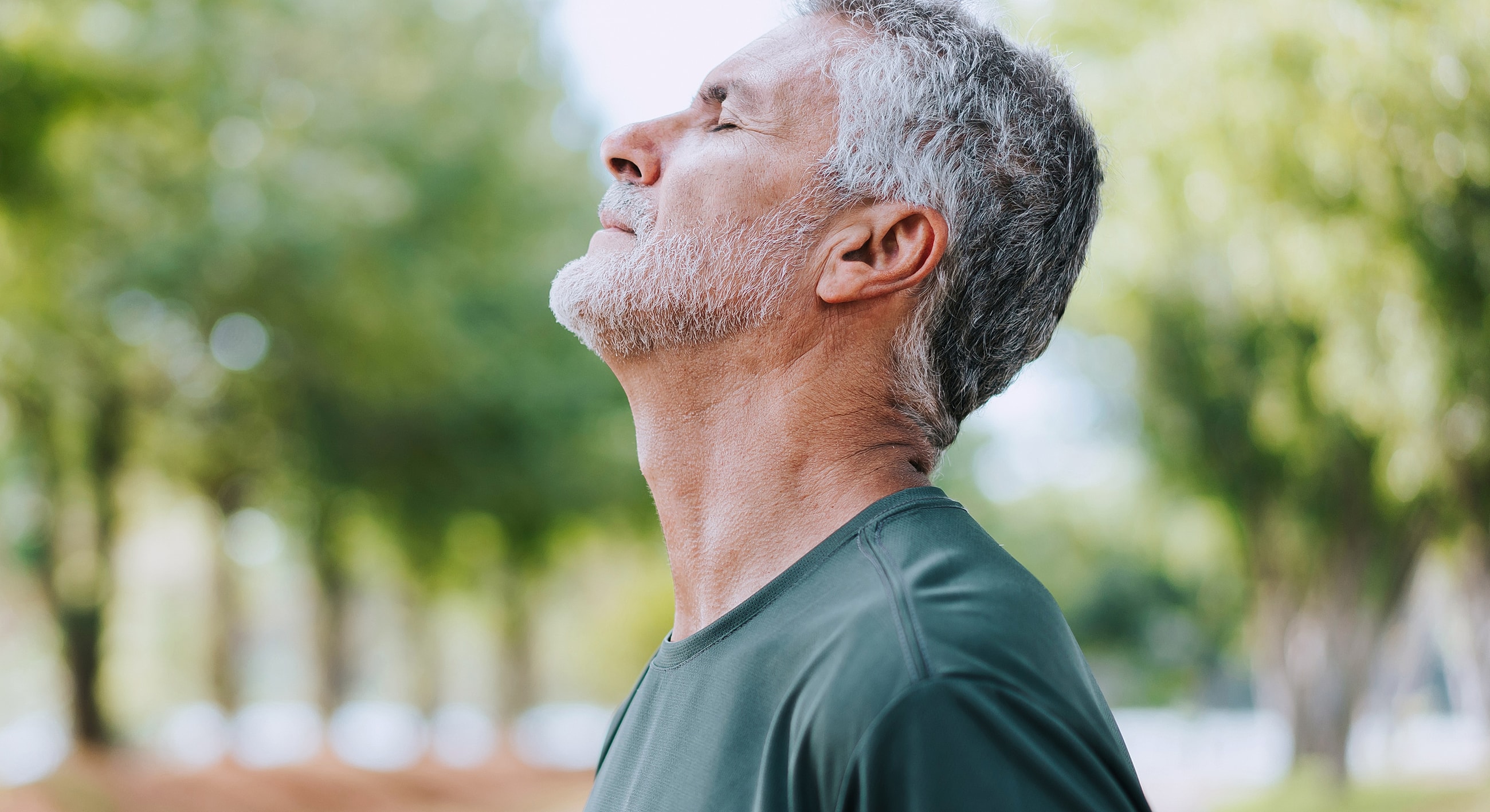 Man enjoying nature with eyes closed.