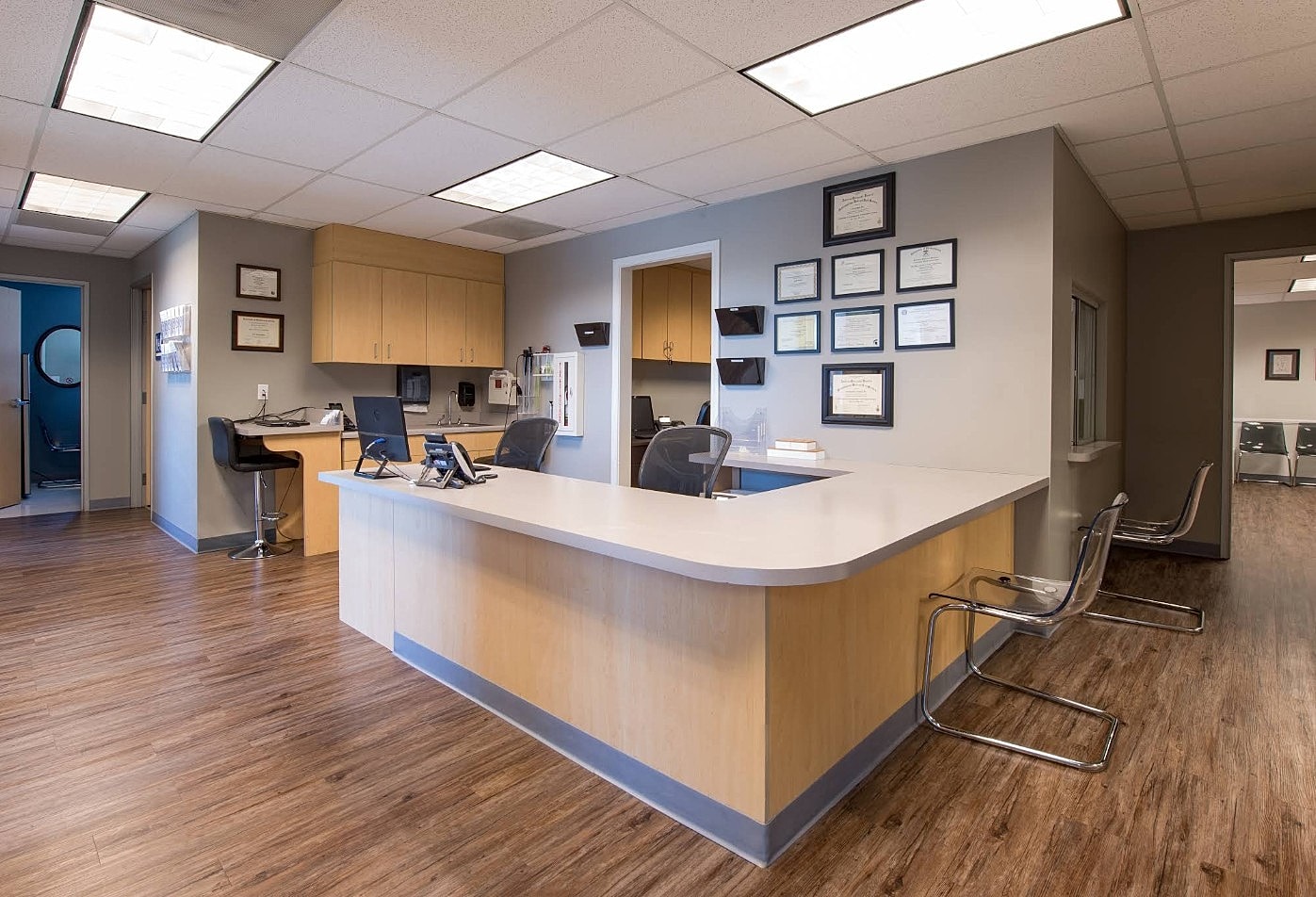 Modern office reception area with wooden flooring.