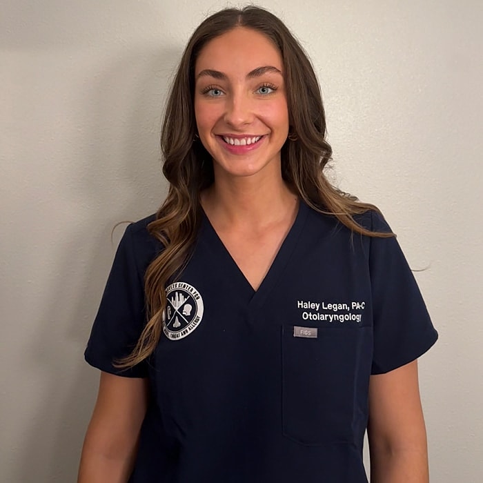Smiling healthcare professional in scrubs.