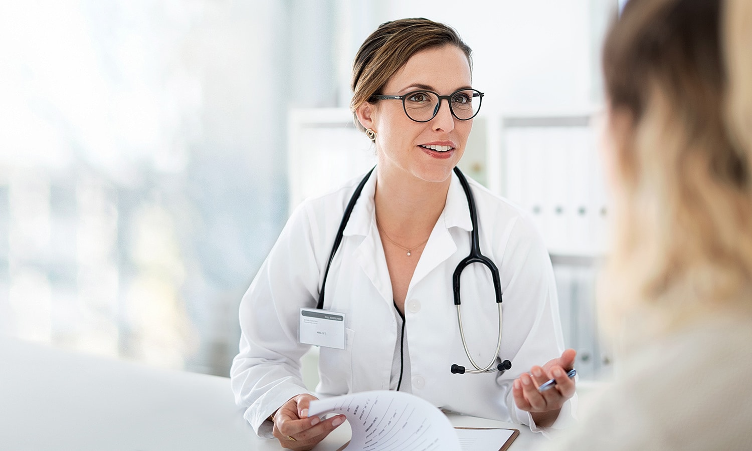 Doctor consulting with a patient in office.