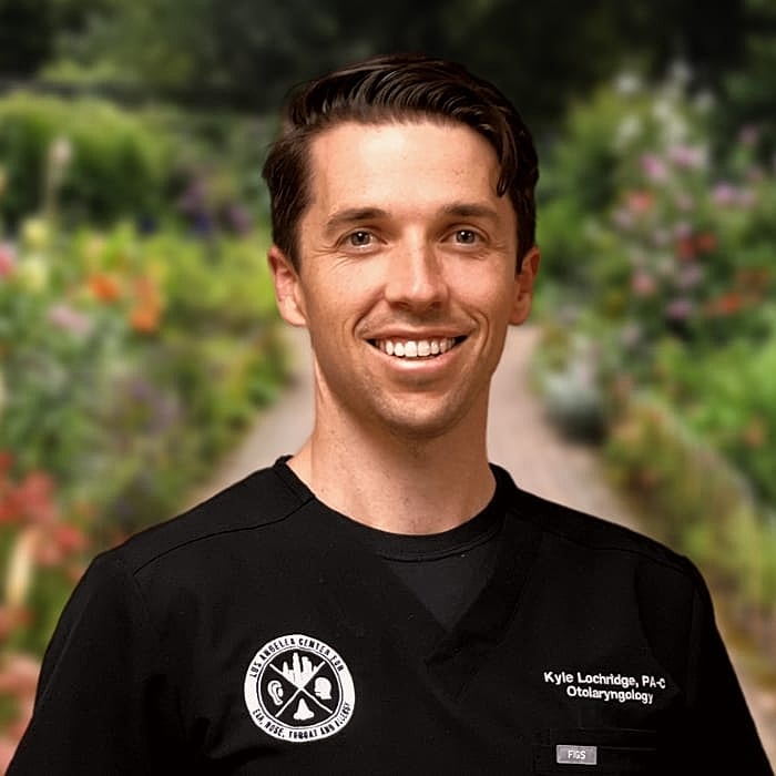 Smiling healthcare professional in nature setting.