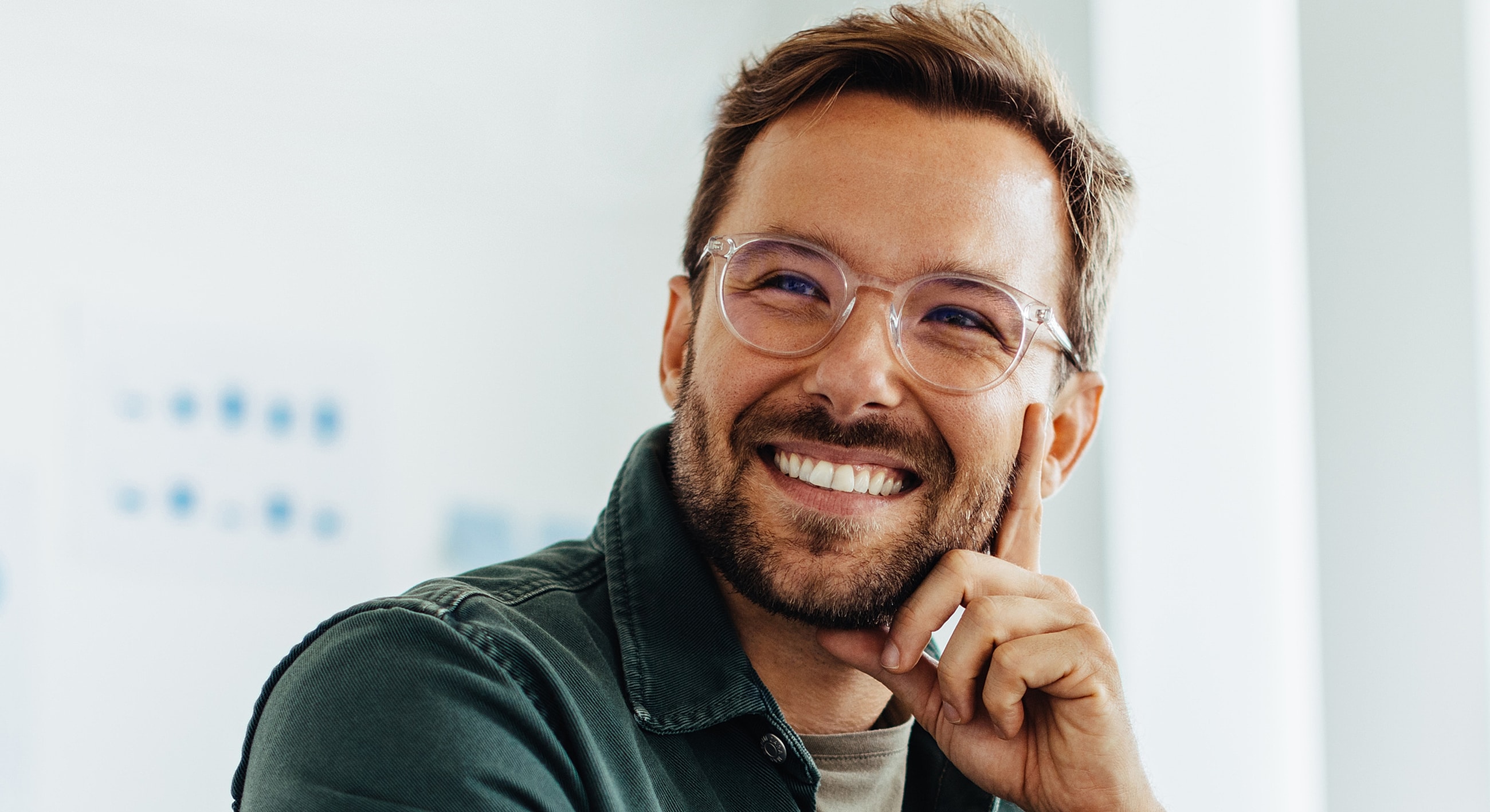 Smiling man with glasses in a bright setting