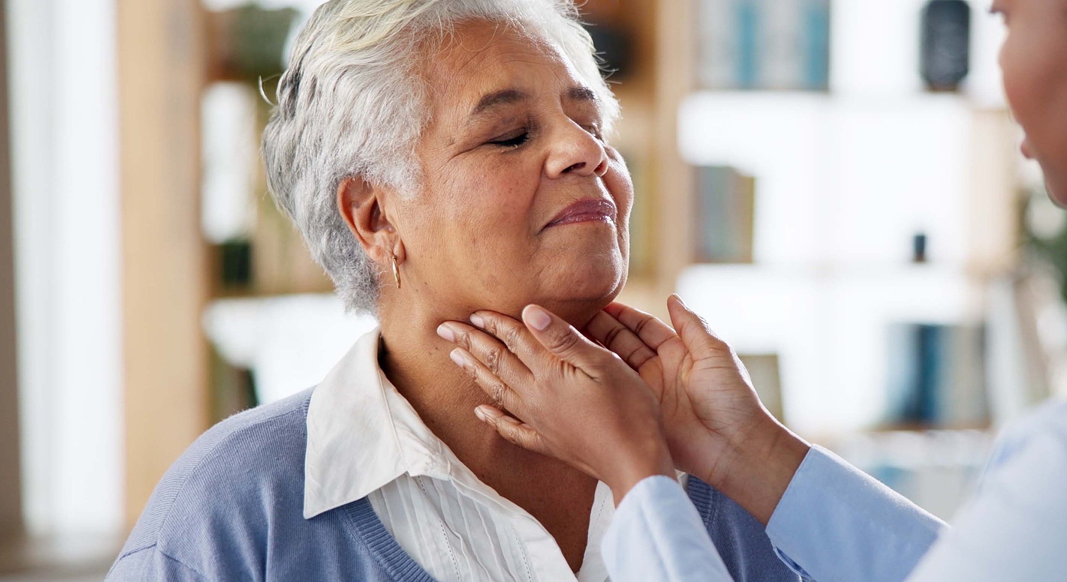 Patient receiving dental examination from healthcare professional.